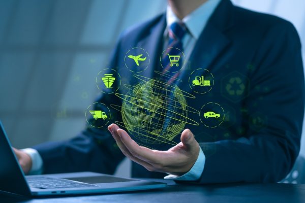 Businessman Using Computer With Icons About Green Transportation