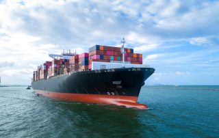Aerial Side View Of Cargo Ship Carrying Containers