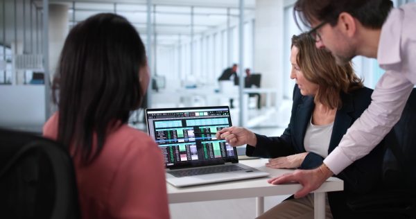 Professional Team Analyzing Billing Report Using Spreadsheet Software In Office