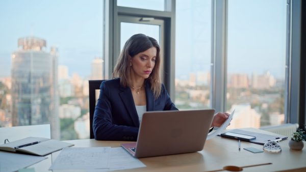 Focused CFO Executive using Laptop